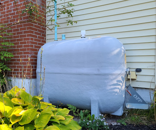 an old white oil tank outside of home ready for removal